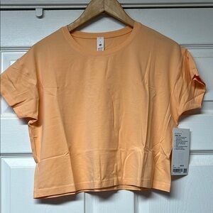 Lululemon Athletica Cates Tee. Orange Boxy Crop Top